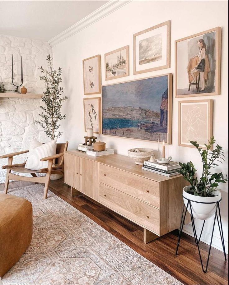 a living room filled with furniture and pictures on the wall above it's fireplace