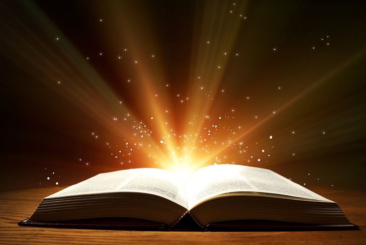 an open book with bright light coming out of the pages and shining stars in the background