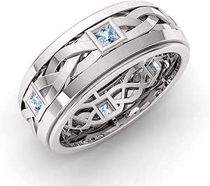 a white gold wedding band with princess cut diamonds and blue topaz stones in the center