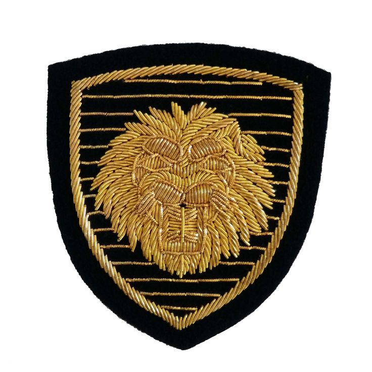 a black and gold patch with a lion on it's chest, in front of a white background