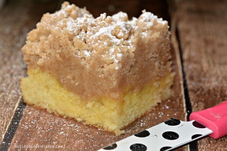 a piece of cake sitting on top of a wooden table next to a spatula