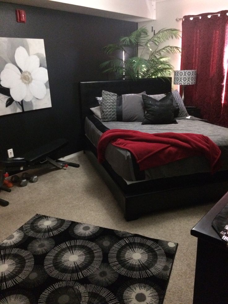 a bed room with a neatly made bed and rugs