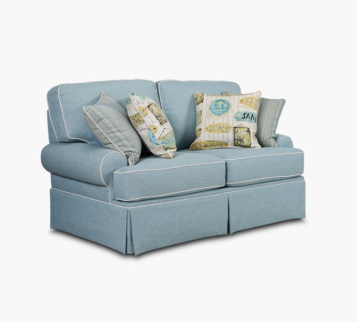 a blue couch with several pillows on it's back and the seat folded down