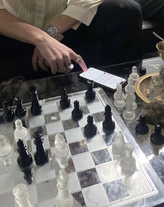 a man sitting at a table playing chess