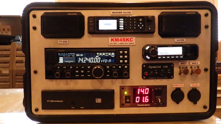 an old radio sitting on top of a table next to a clock and other electronic equipment