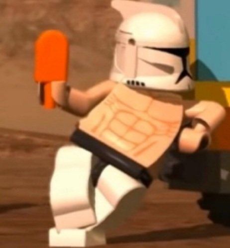 a lego star wars character is holding an orange object in one hand and wearing a helmet on the other