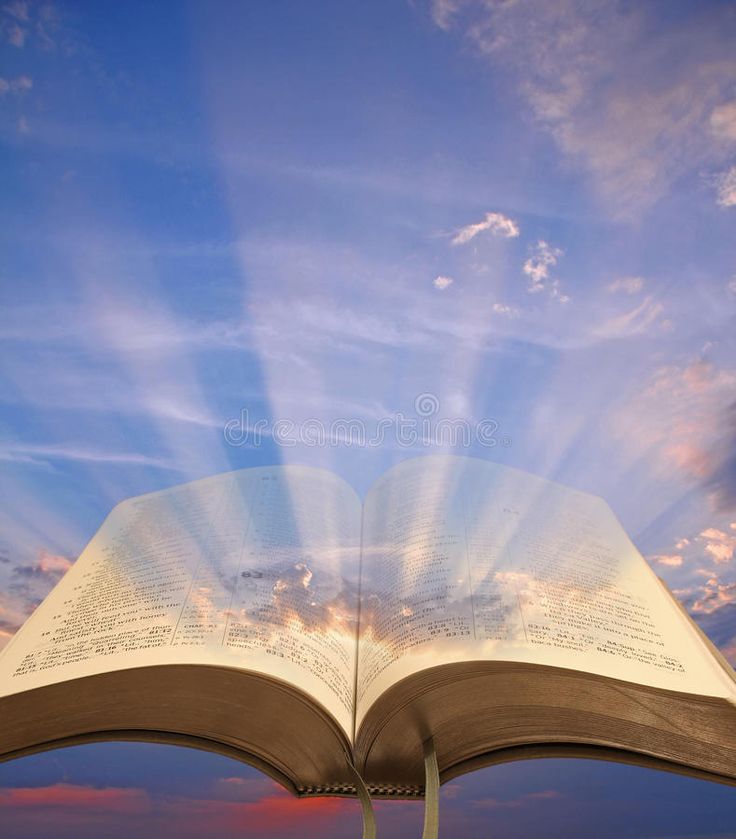 an open book with the sun shining down on it and clouds in the sky above