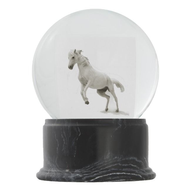 a snow globe with a horse running inside