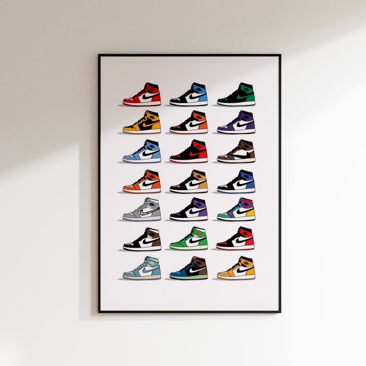 a framed poster with different colored sneakers on it's wall above a white table