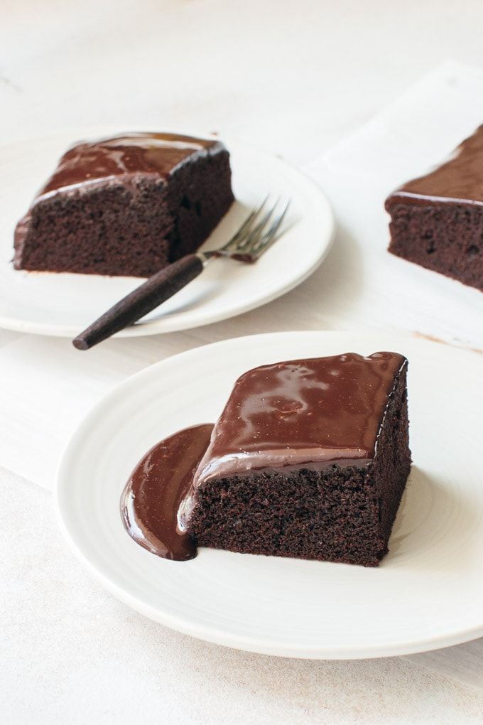 three plates with slices of chocolate cake on them