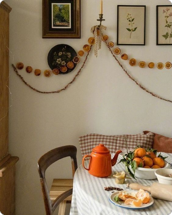 a dining room table with food on it and pictures hanging over the wall behind it