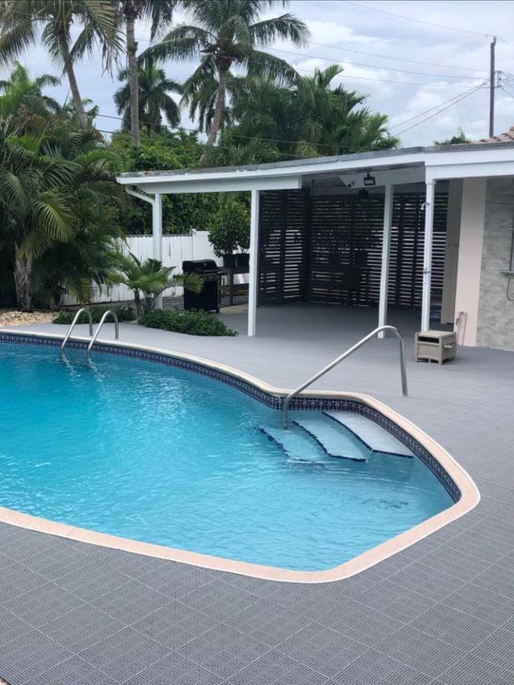 grey interlocking patio tiles installed on outdoor pool deck flooring Pool Deck Tile, Decks And Patios, Outdoor Tile, Backyard Seating Area, Outdoor Pool Area, Dream Life House, Patio Tiles, Backyard Pool Landscaping, Garden Design Ideas