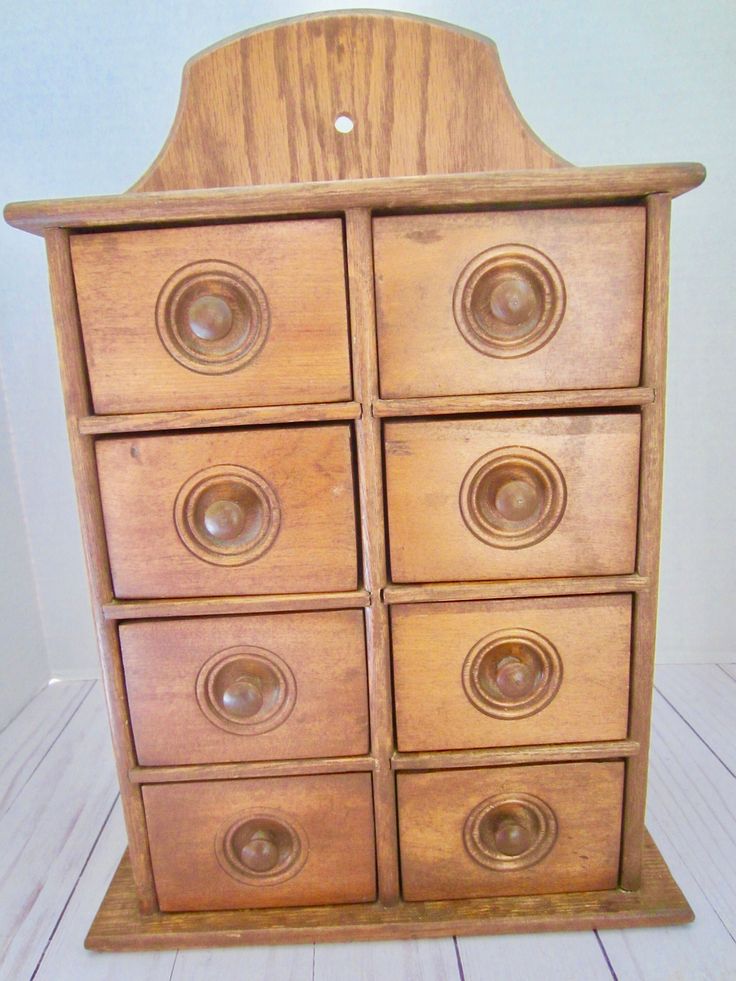 a wooden dresser with six drawers and knobs