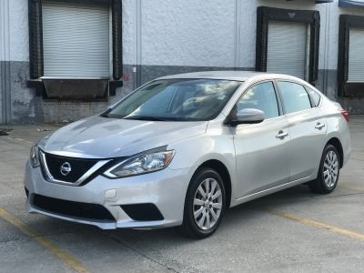 a silver car is parked in the parking lot