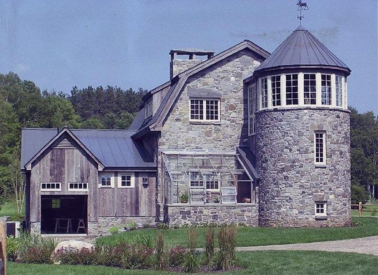 an old stone house with a metal roof