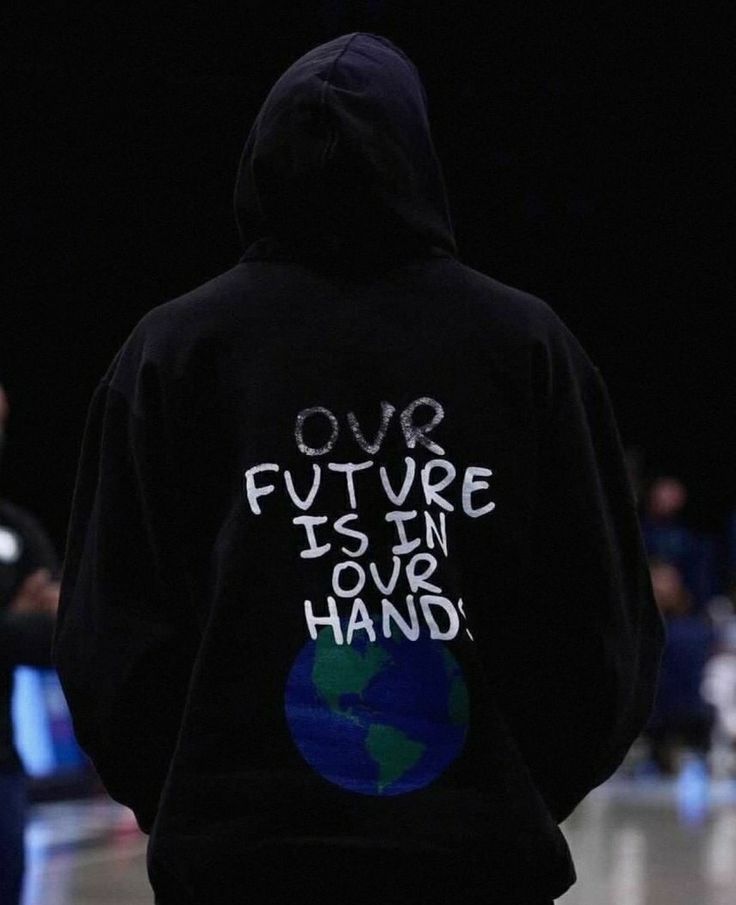 a person wearing a black hoodie with the words our future is in our hand on it