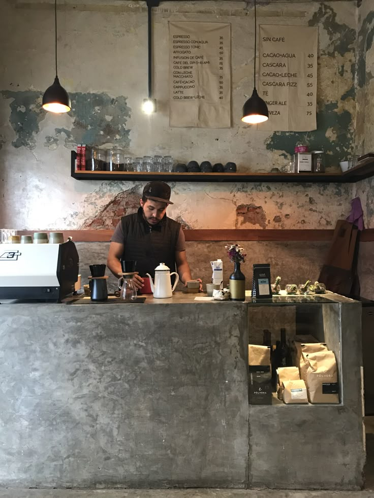 a man standing behind a counter in a restaurant