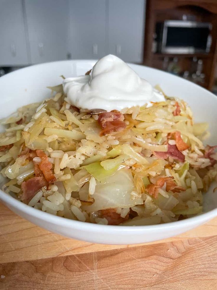 a white bowl filled with food on top of a wooden table