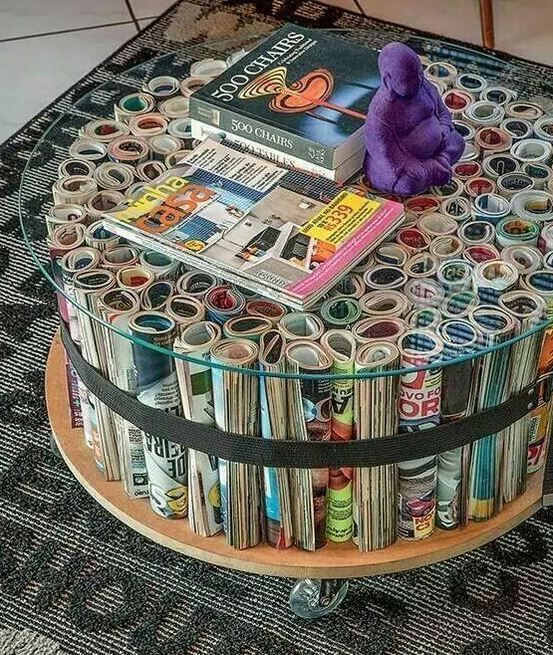 a round table made out of magazines with a purple stuffed animal on top of it