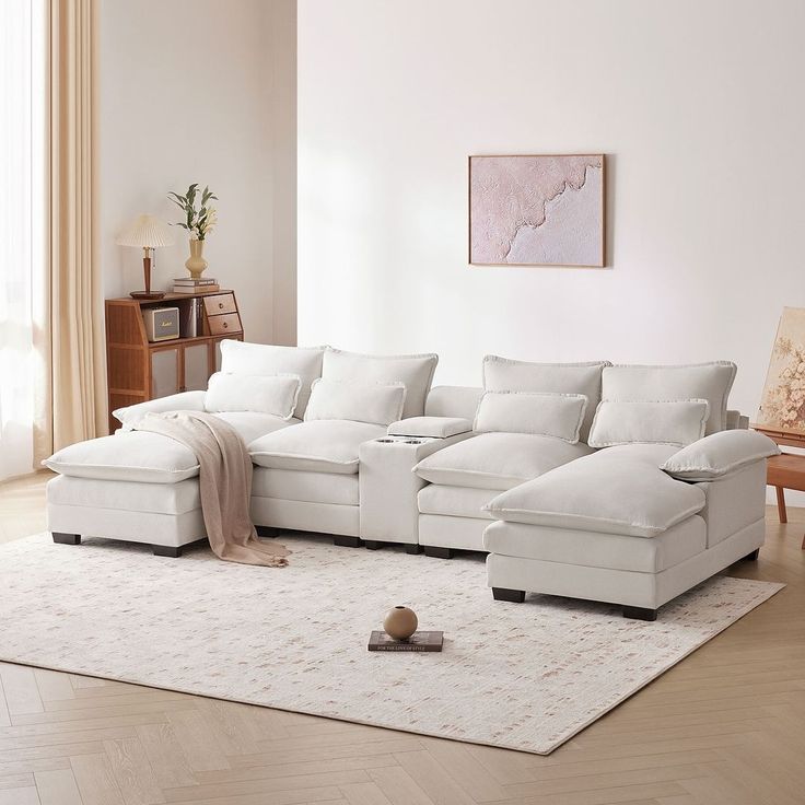 a living room with a large white sectional couch