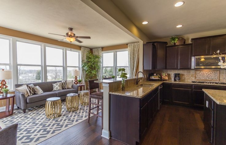 a kitchen and living room with large windows