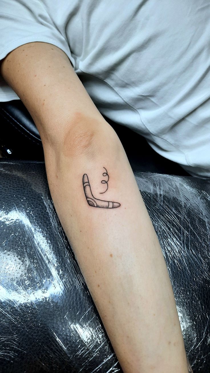 a person with a small tattoo on their arm