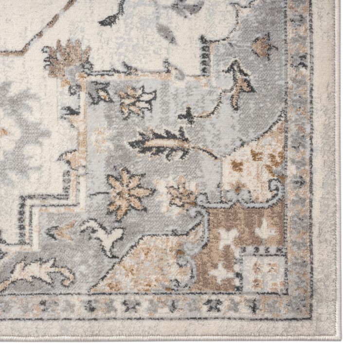 an area rug with various colors and patterns on the floor, including greys, oranges, yellows and browns