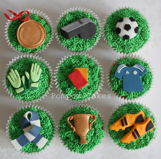 cupcakes decorated with green frosting and sports related decorations