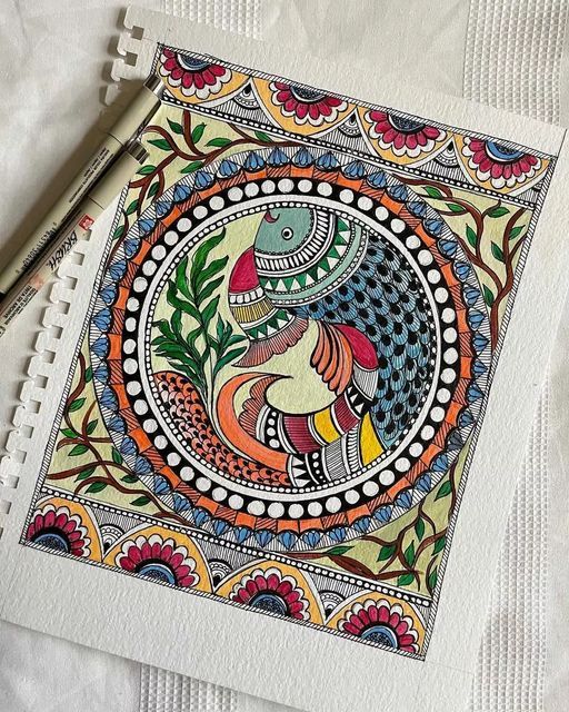 an intricately decorated notebook with a pen on it