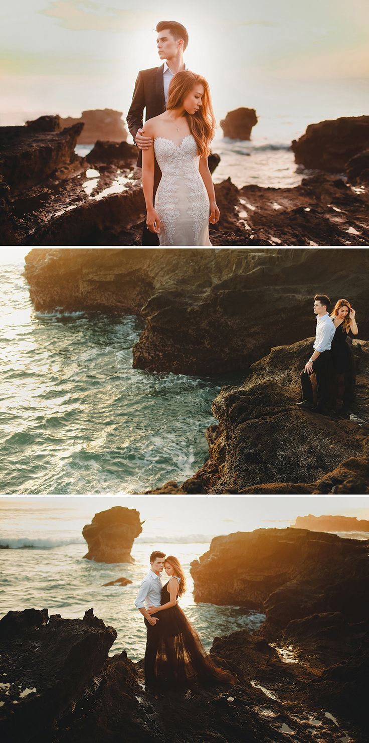 two people sitting on rocks near the ocean and one person standing in front of them