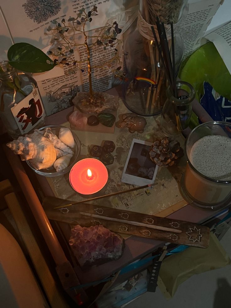 a table topped with lots of food next to a candle