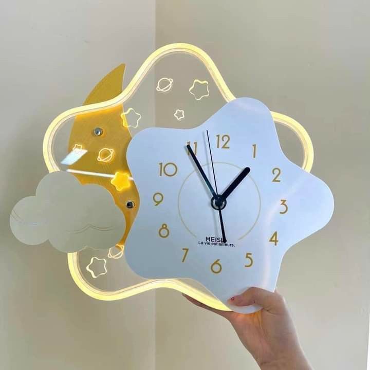 a person holding up a clock that is shaped like a cloud and a fox with stars on it