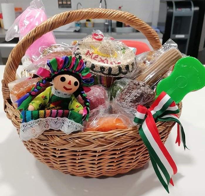 a basket filled with lots of different types of food and candy on top of a table