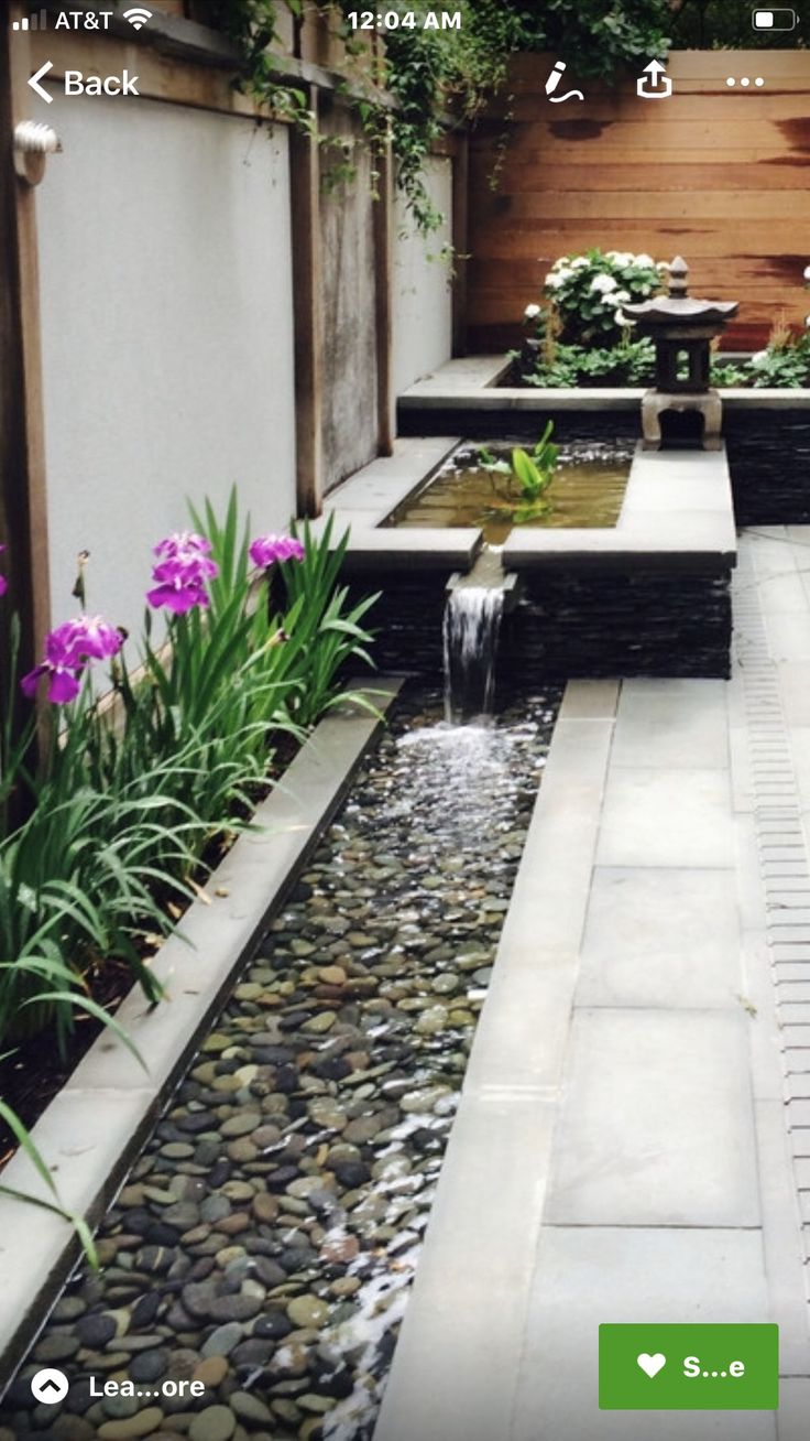 an outdoor garden with water features and landscaping