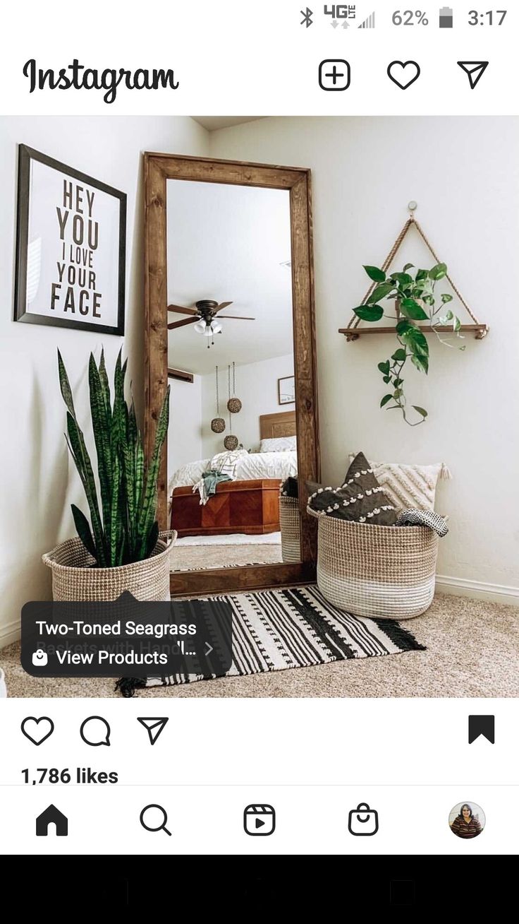 an instagram page with a mirror and potted plants on the floor in front of it