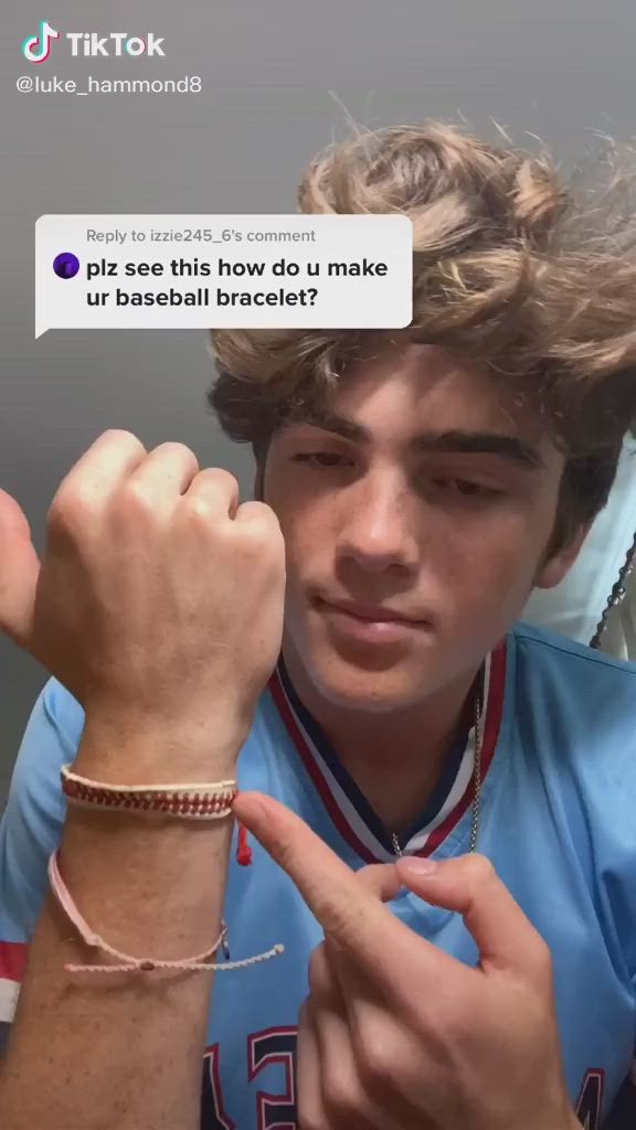 This may contain: a young man wearing two bracelets and a tweet on his wrist with the caption