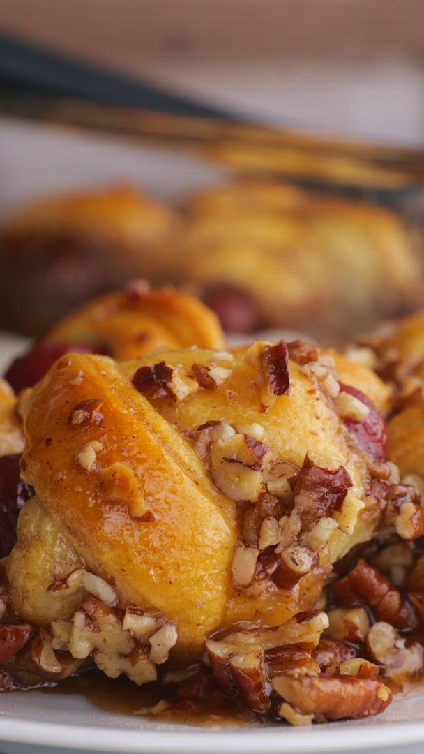 This may contain: a casserole dish filled with baked goods like bread, beans and other toppings