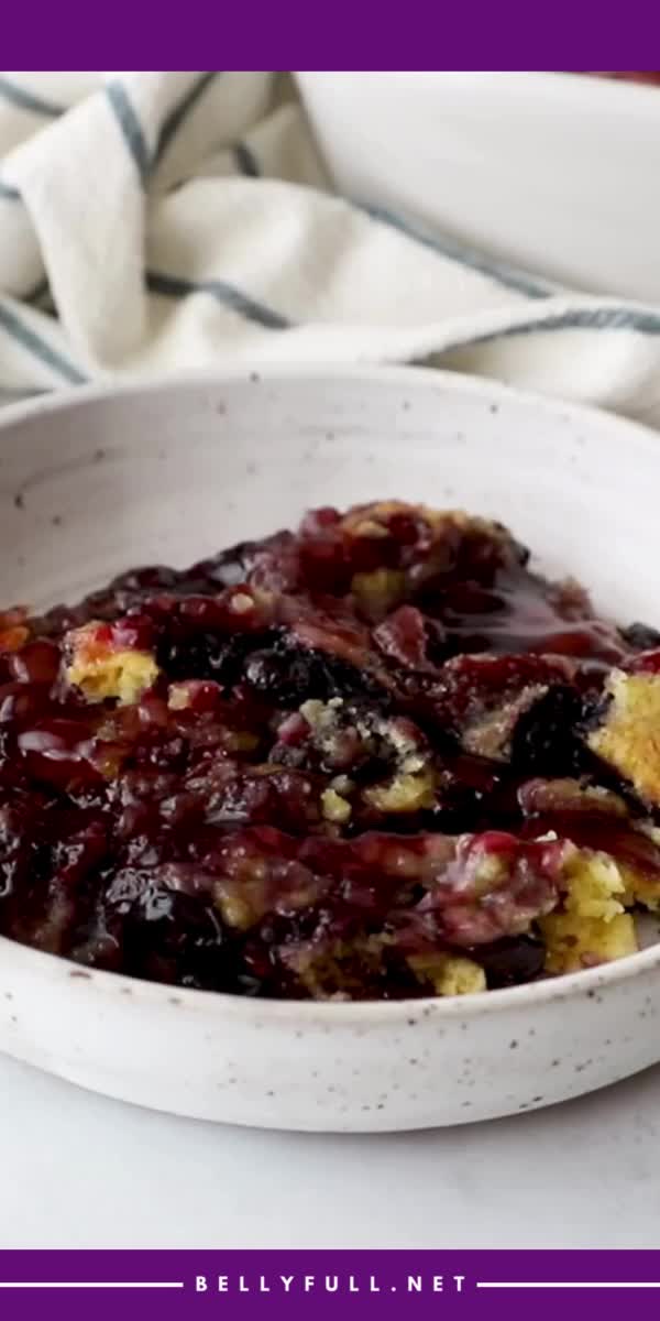 This contains: An easy dessert idea, this Blueberry Dump Cake recipe requires just 4 ingredients and 5 minutes of prep! With blueberry pie filling, lemon cake mix, melted butter, and blueberries, it’s best served with a scoop of vanilla ice cream!