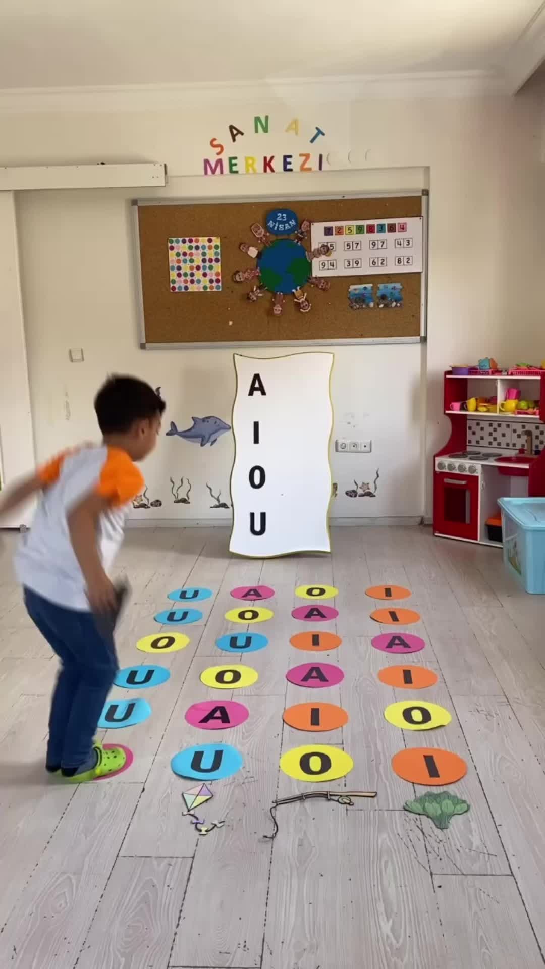 This may contain: a young boy is playing with letters on the floor