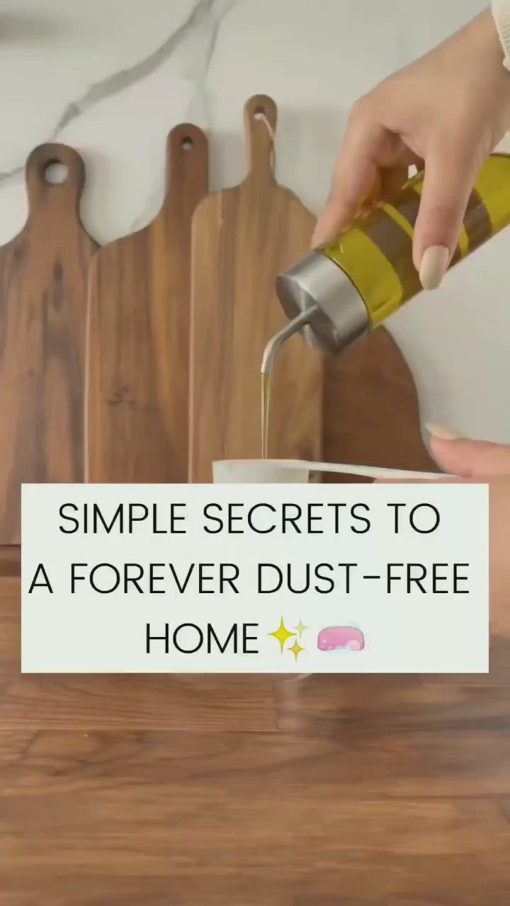 This may contain: a person is pouring olive oil into a cup on a cutting board with the words, simple secrets to a forever dust - free home