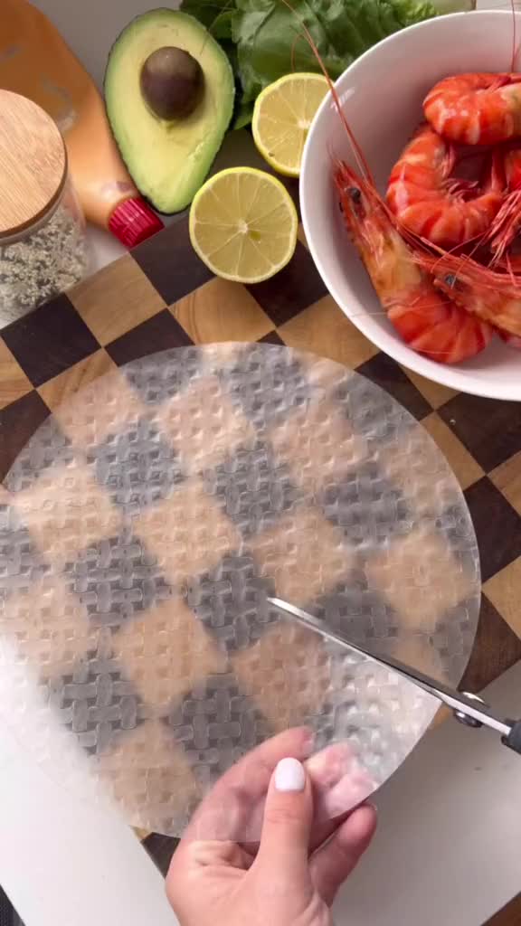 This may contain: a person cutting up some food on top of a table