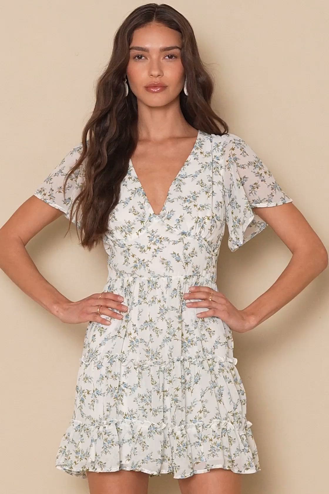 Every compliment will be totally accurate in the Lulus So True White Floral Print Tiered Short Sleeve Mini Dress! Textured, lightweight woven chiffon, in a dainty white, blue, and green floral print, falls from a V-neckline, into fluttering short sleeves. A high, set-in waist sits above a flirty tiered mini skirt. Hidden back zipper/clasp. Fit: This garment fits true to size. Length: Mid-thigh. Size medium measures 34.5" from shoulder to hem. Bust: Works best for A to C cup sizes. Waist: Fitted 