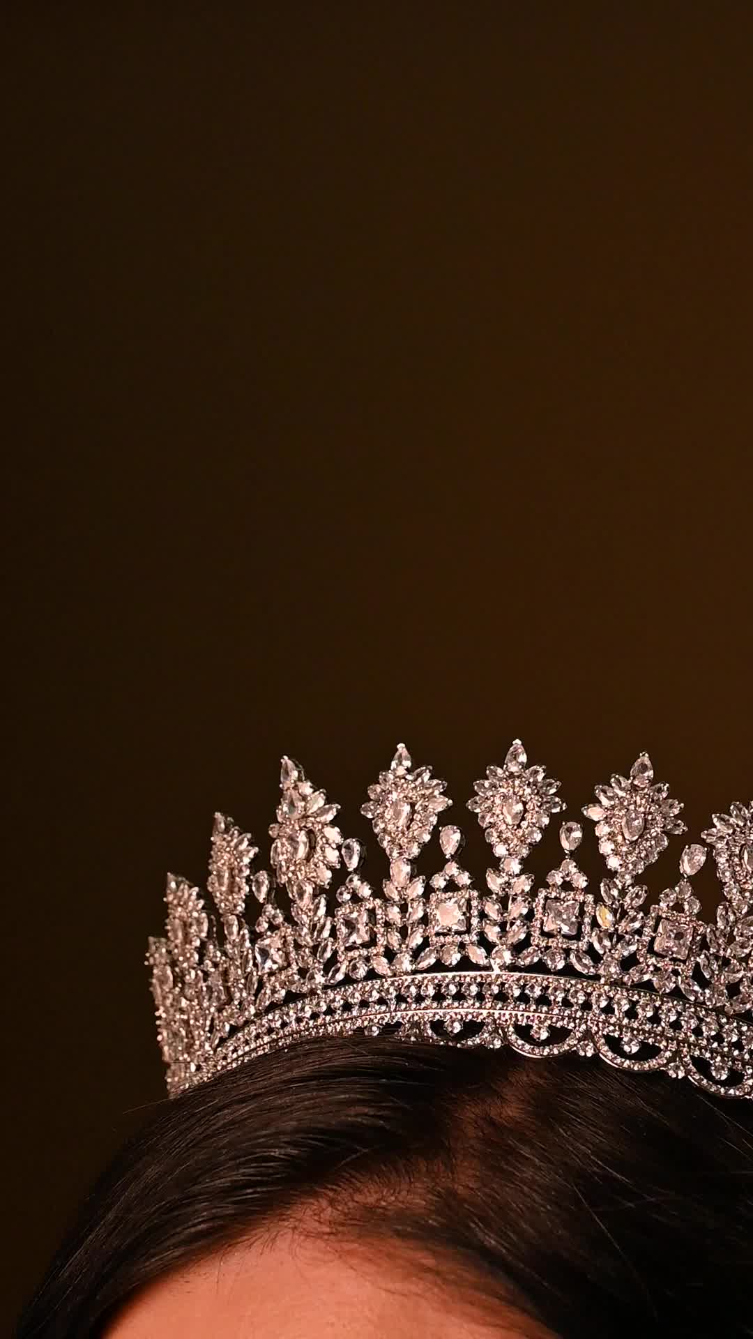 Our FARAH Swarovski Crown has a luxurious design with a majestic look. It includes and unique design that is surrounded with different shaped crystals. This is one of our brides favorite bridal or special occasion crown to add a touch of royalty to the bridal or final look. It is a great fit for a princess on her wedding or special day. The best way to secure it: Pin it down with bobby pins on any part of the crown including the loops on both sides. Handcrafted Highest Quality Swarovski / Cubic 