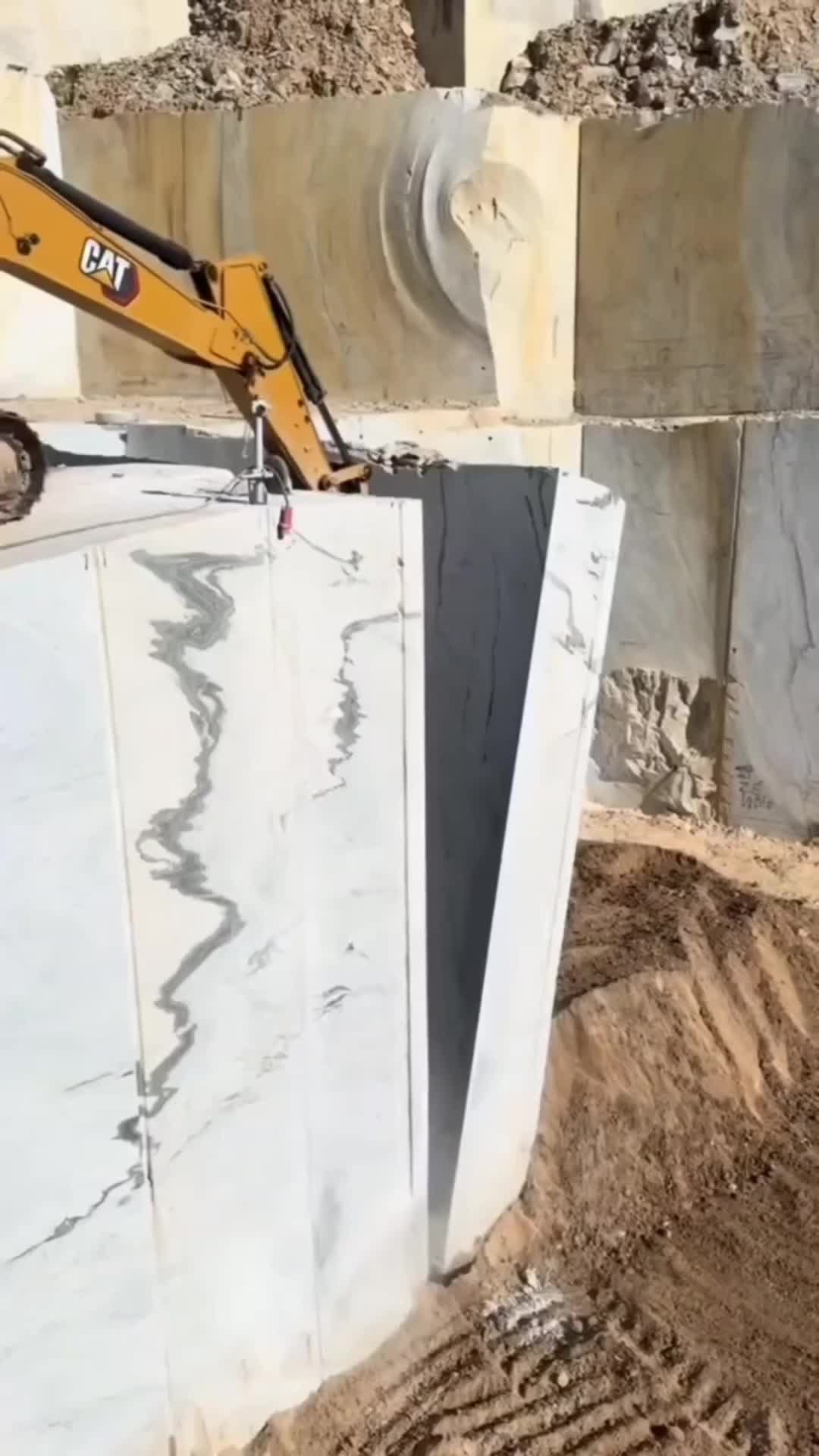 This may contain: an excavator digging through the ground in front of a building under construction