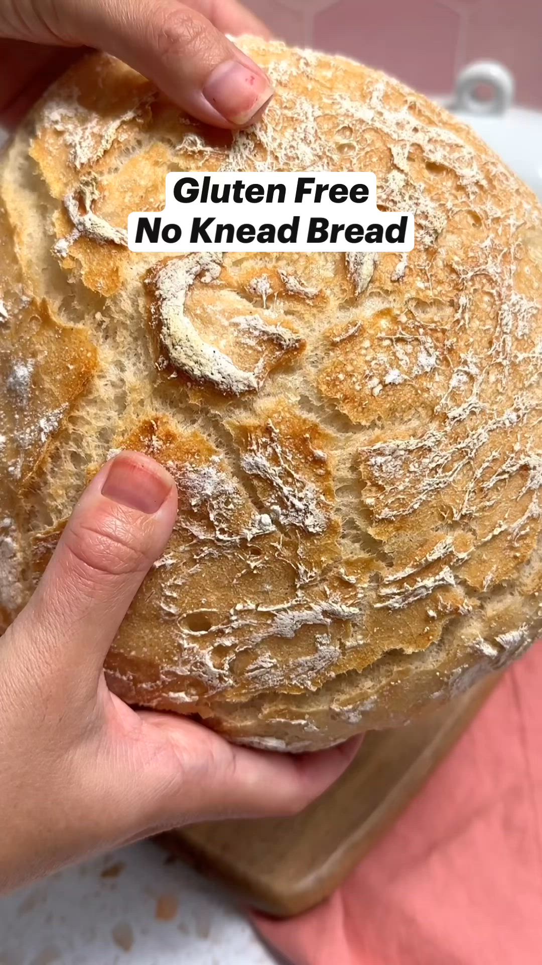 This may contain: a person holding a loaf of bread in their hand with the words gluten free no knead bread