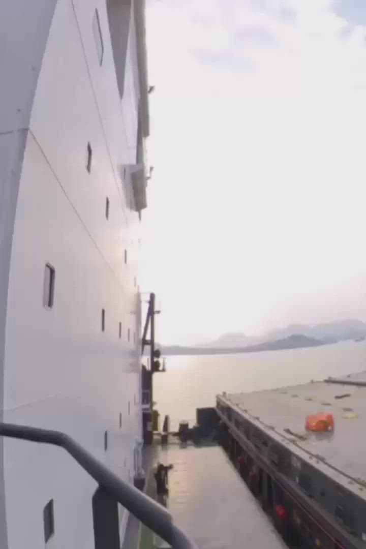 This may contain: a large boat docked in the water with another boat on it's back end