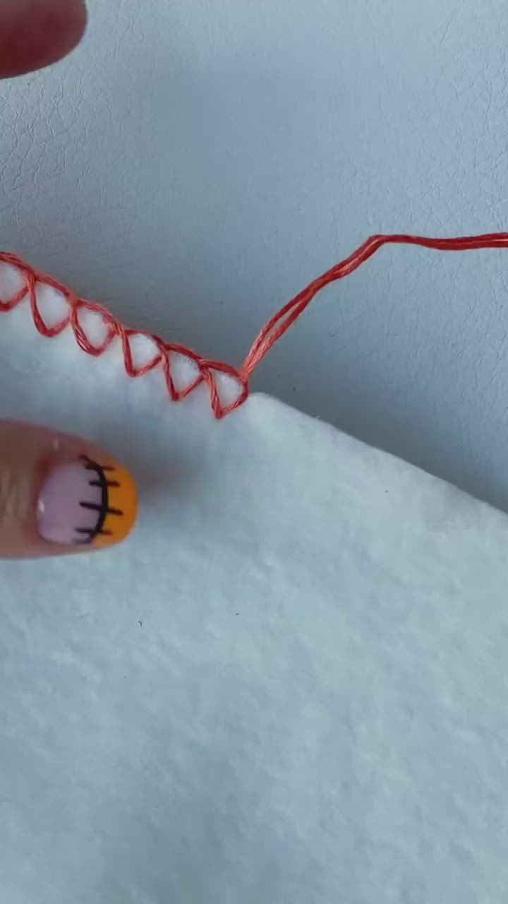 This may contain: someone is doing something that looks like a toothbrush and has been painted with red thread