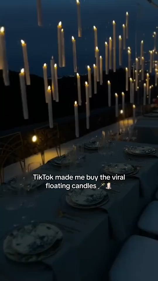 This may contain: a long table is set with candles and place settings for the dinner guests to enjoy