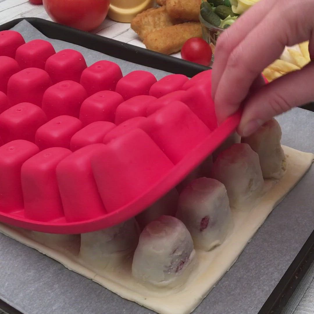 This may contain: a person is placing dough into a tray