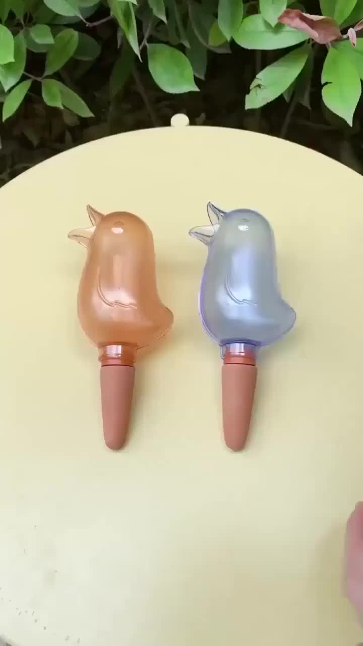 This may contain: two plastic birds sitting on top of each other